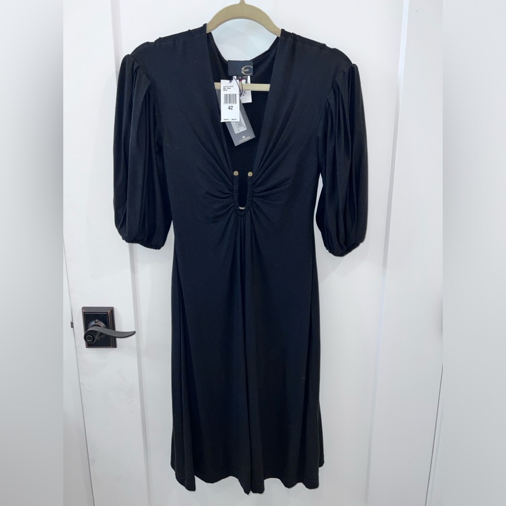 Just Cavalli Black Italian dress. I’m 5’4. Dress falls just below my knees.